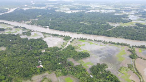 aerial flying over flooded low lands and overflown river in northern bangladesh