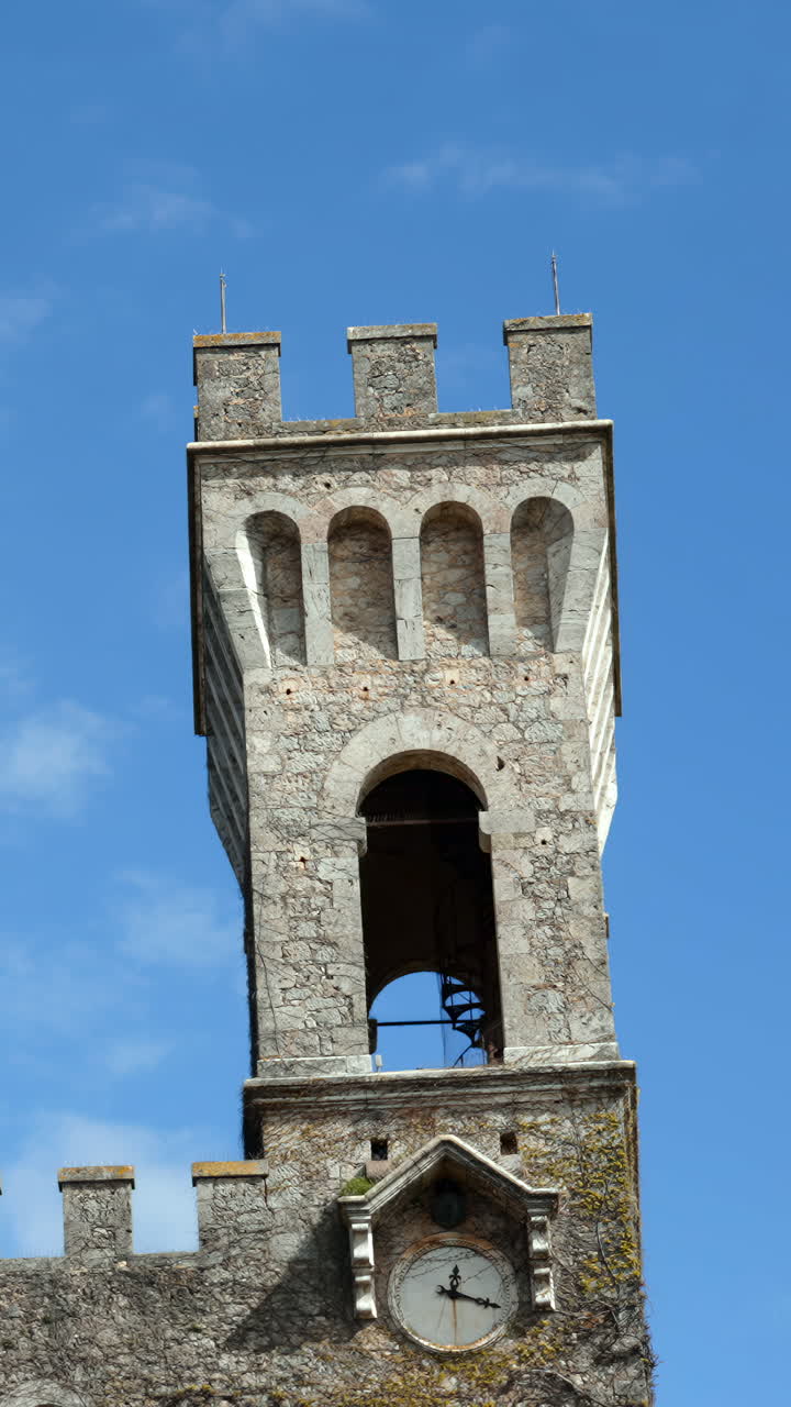 Historic Stone Clock Tower against a Blue Sky