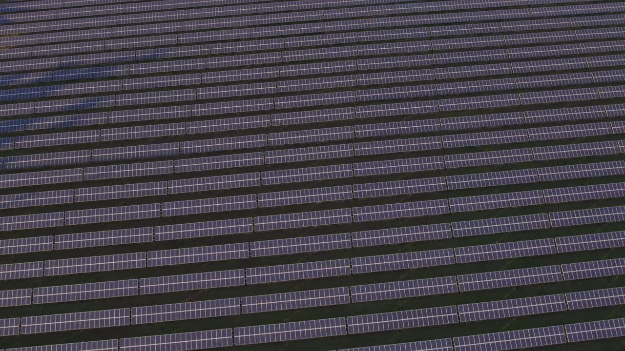 view from a drone on solar energy collectors at sunset