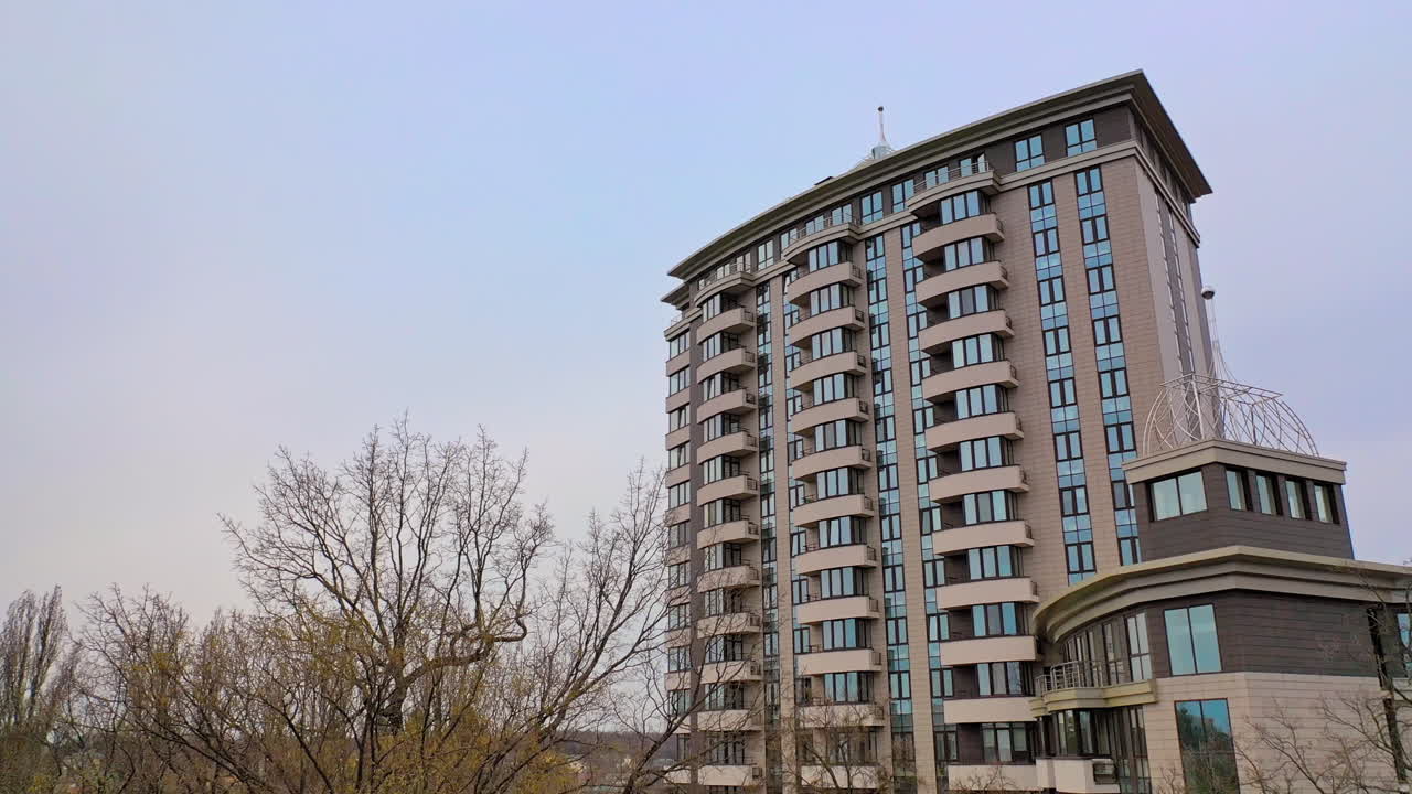 Newly built modern multy-storey building in the urban district. New design for high structure. Camera motion bottom up