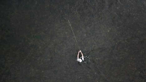 Bird's-Eye-Drone-Shot-above-a-man-Fly-Fishing-in-the-Provo-River-in-the-Mountains-of-Utah-2