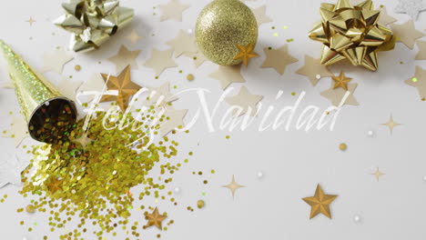 feliz navidad text animation over christmas decorations with stars and glitter