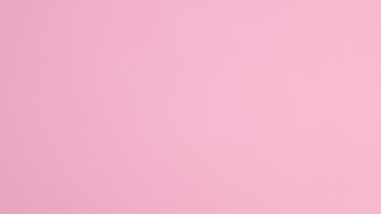 Summer trendy beach accessories appear on pastel pink background. Stop motion flat lay