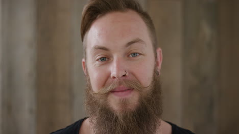 close up young hipster punk man with beard smiling happy enjoying successful lifestyle handsome independent male