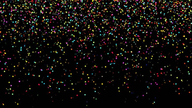 Confetti colorati che cadono su uno sfondo nero