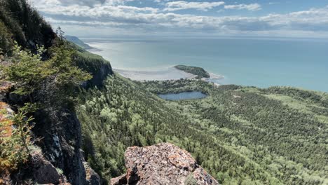 lush green forest by the coastal mountains at bic national park surrounded by the calm coast in rimouski, quebec, canada