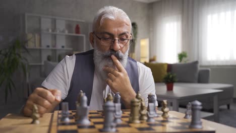 Man-playing-chess-alone-at-home.