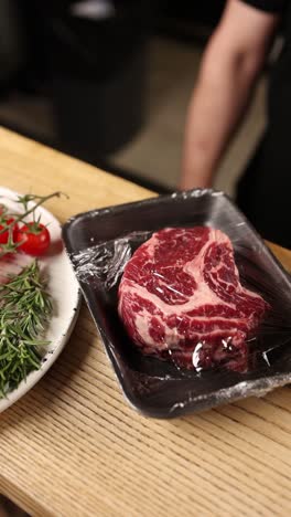 chef preparing raw ribeye steak