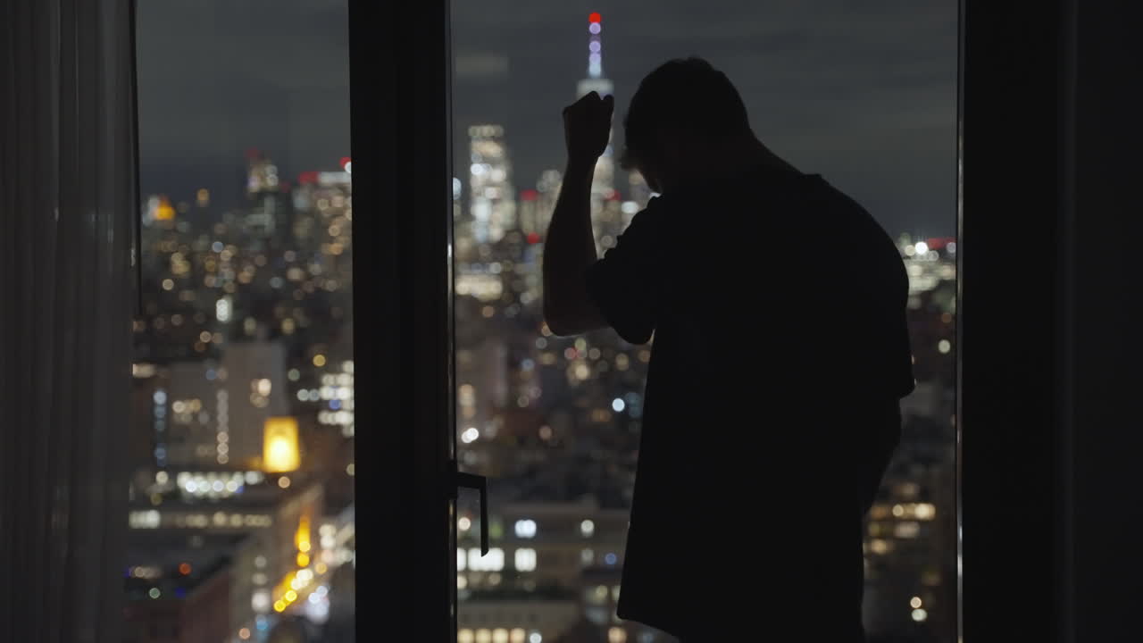 Man standing next to window in apartment hotel or office disappointed ...