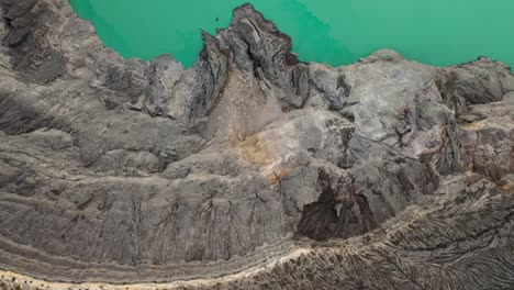 dramatic top aerial view of a crater acid lake kawah ijen where sulfur is mined