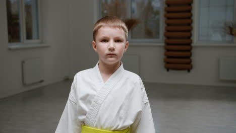 boy in white kimono in martial arts class