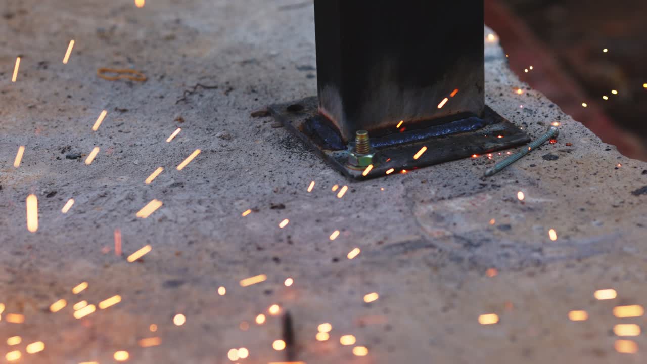 Sparks falling from welding in construction site.