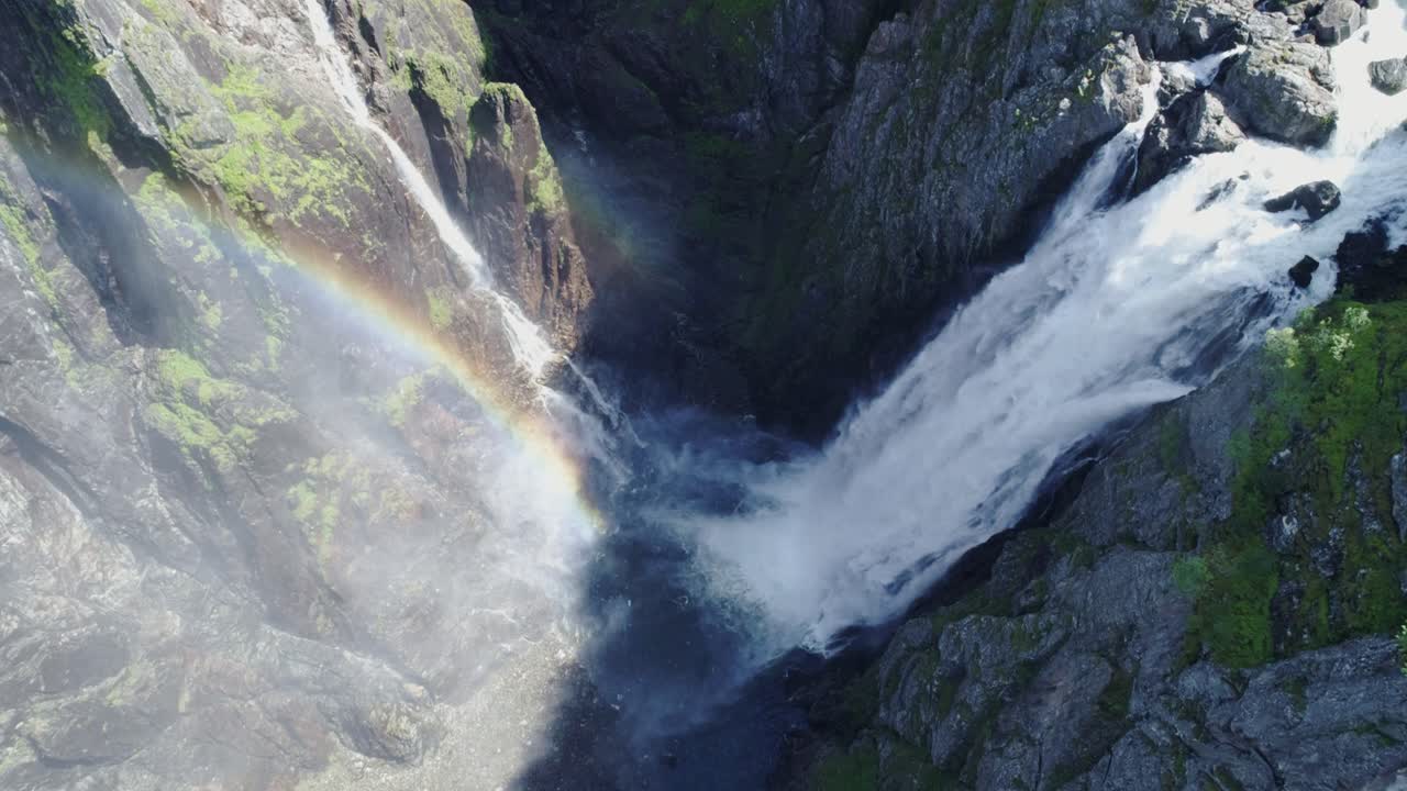 Majestic Waterfall with Rainbow in a Scenic Canyon