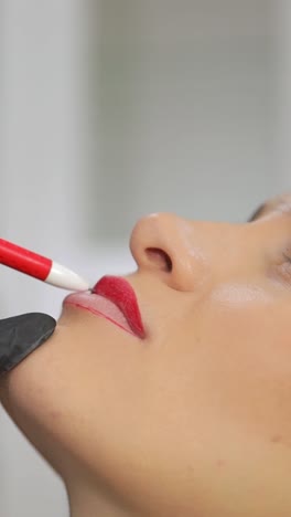 makeup artist skillfully applies bold red lip color, showcasing exceptional beauty, artistic techniques, and creativity
