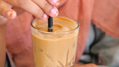 person drinking iced coffee