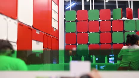 people engaging with colorful wall blocks