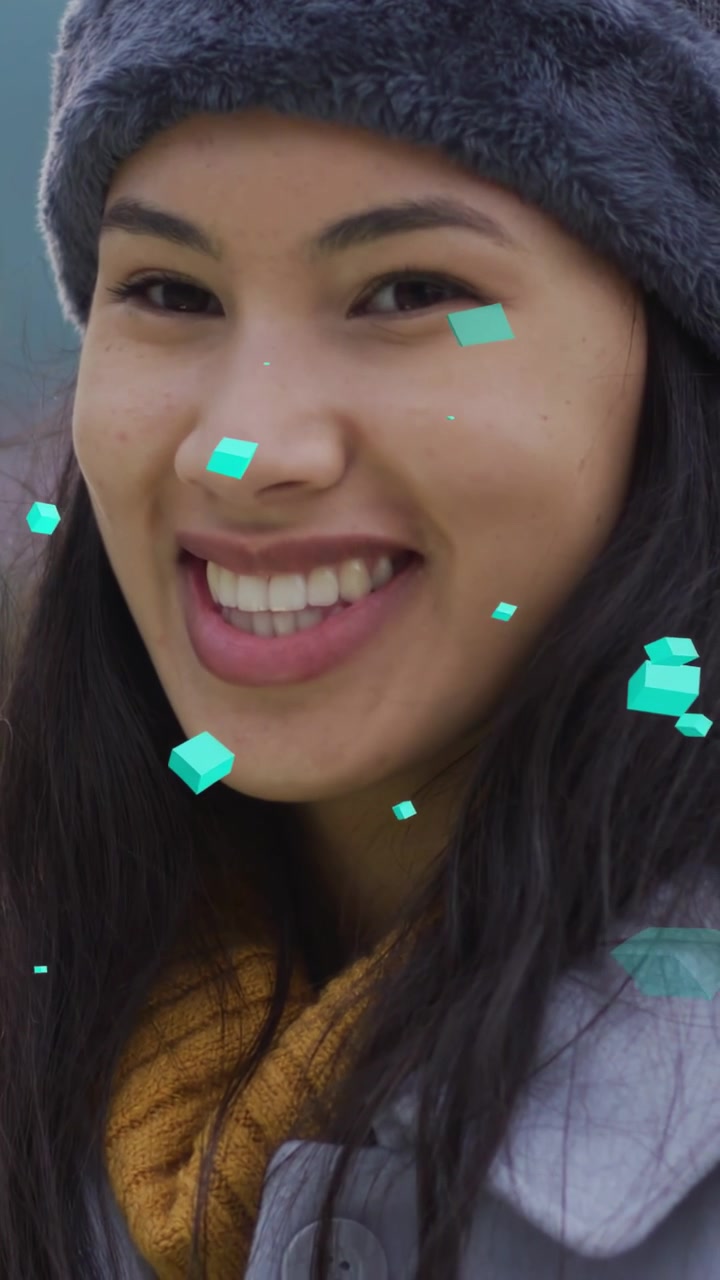 Vertical video: Woman lifting gaze with teal 3D shapes moving, smiling as camera zooming for ads