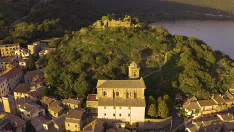 aerial pullback reveals historic center of trevignano with fortress in background