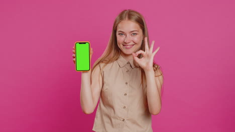 developer woman girl hold smartphone with green screen chroma key mock up recommend good application