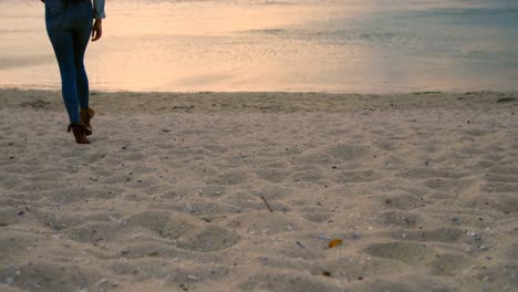 woman walking on beach 4k