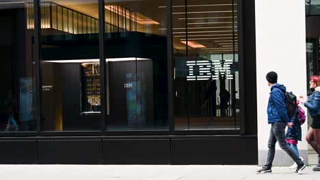 people walking past an ibm office building
