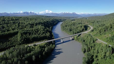 cars driving over chulitna river bridge on george parks highway alaska