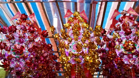 On-the-third-day-of-the-Chinese-Lunar-New-Year,-big-windmill-in-the-stall-for-sale,-Sha-Tin,-Hong-Kong,-7-Feb-2019