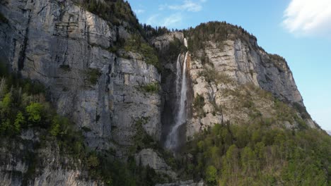 Aerial-alpine-waterfall-mountainside-Seerenbach-Falls,-Weesen-Switzerland