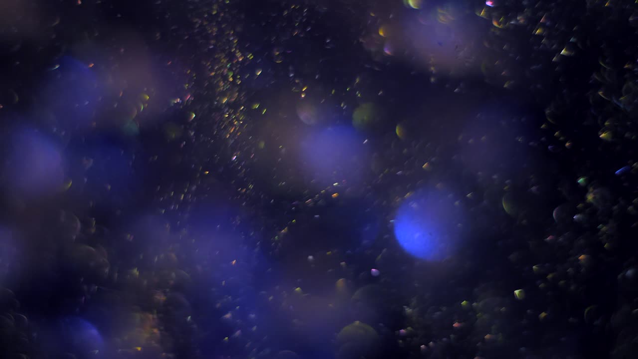 las partículas de bokeh azul mágico parpadeante como burbujas. brillo movimiento de polvo espacial. bucle sin costuras fondo abstracto.