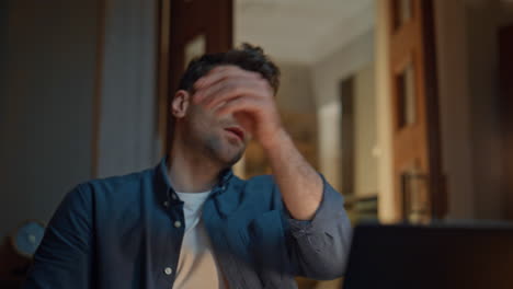 focused entrepreneur typing computer at dark flat closeup. man reacting failure