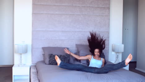 Pretty-woman-jumping-onto-bed