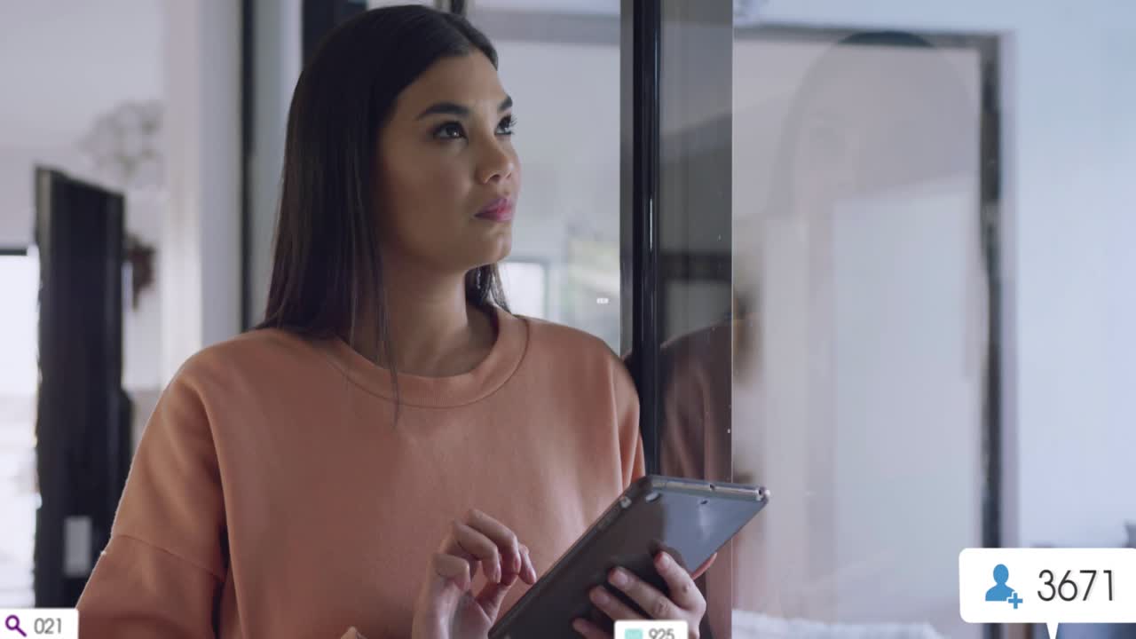 Woman tapping tablet by glass activating multiplying search icons badges tracking marketing metrics