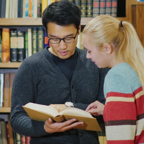 friends of students together look at the book in the library