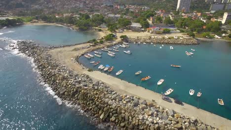 Drone-shot-view-of-the-breakwater-coastline-and-marina-in-the-calm-Caribbean-Sea