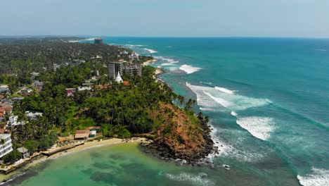 aerial reversing drone shot of coconut hill in sri lanka