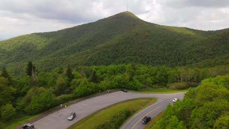 an excellent aerial shot of cars driving along the blue ridge parkway in north carolina