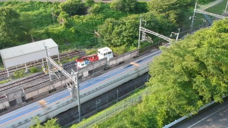 aerial shot of the hokuriku shinkansen passing by just before arriving at karuizawa station on its way to kanazawa station