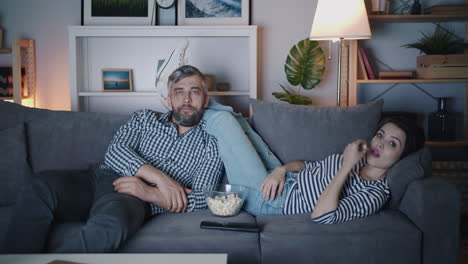 couple relaxing at home watching a movie