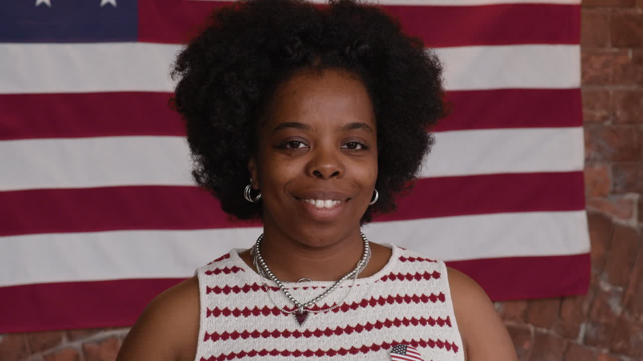 Woman eating a hot dog decorated with an American flag