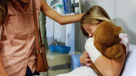 mother giving teddy bear to her daughter 4k