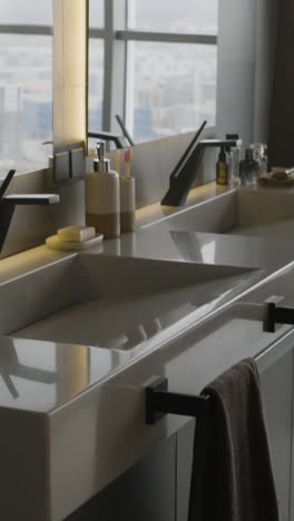 modern bathroom with double sinks and city view