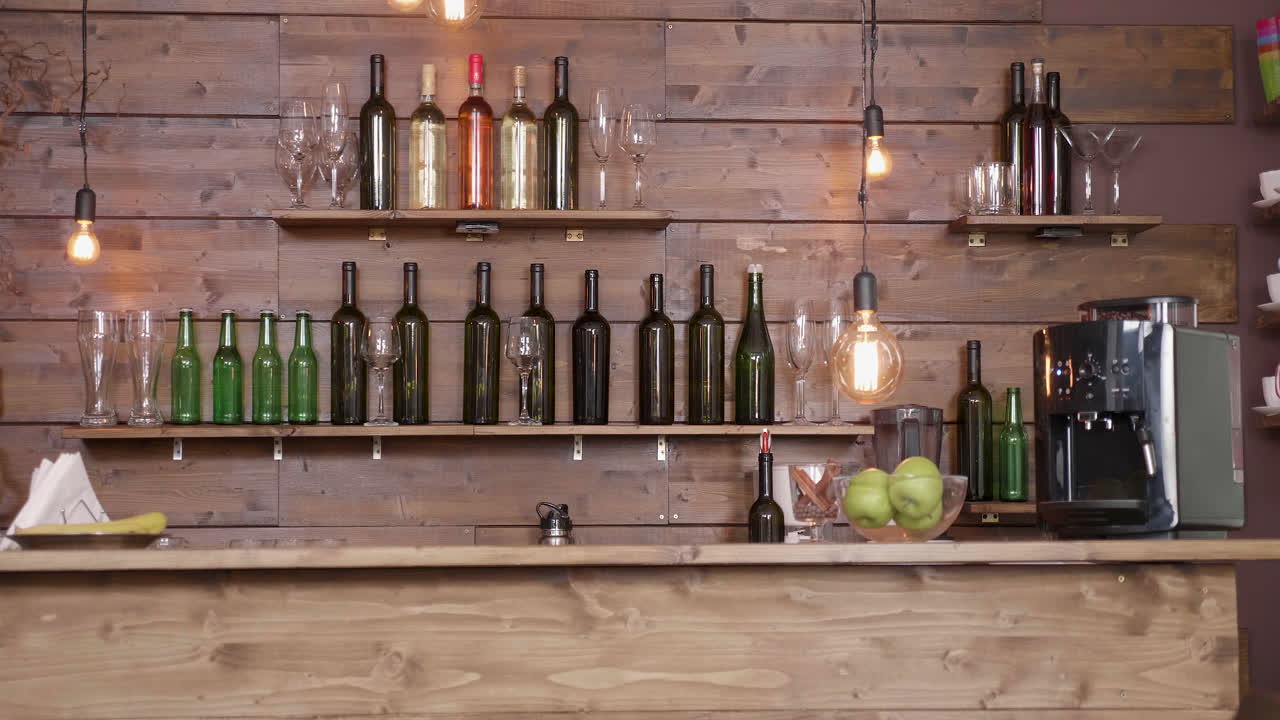 Bar with wine bottles and glasses on wooden shelves