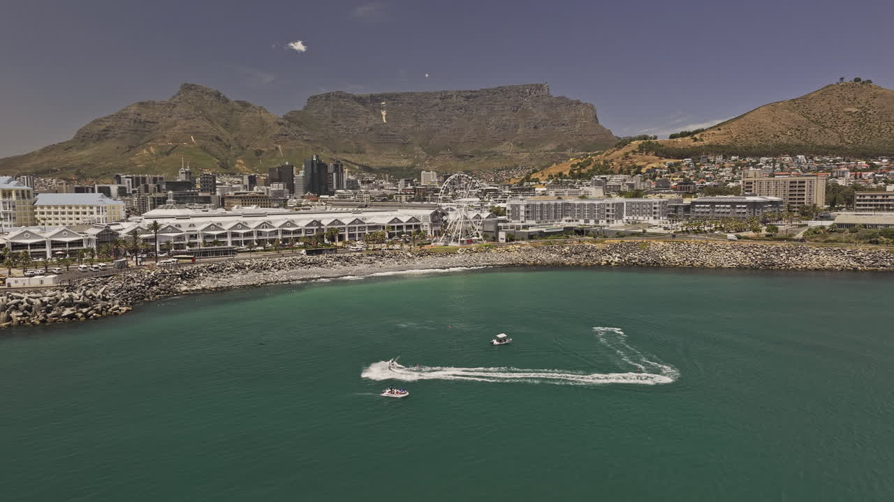 Cape Town South Africa Aerial v45 flyover rocky shoreline capturing V and A Waterfront and downtown cityscape set against Table Mountain and Signal Hill - Shot with Mavic 3 Pro Cine - Jan 11th 2024