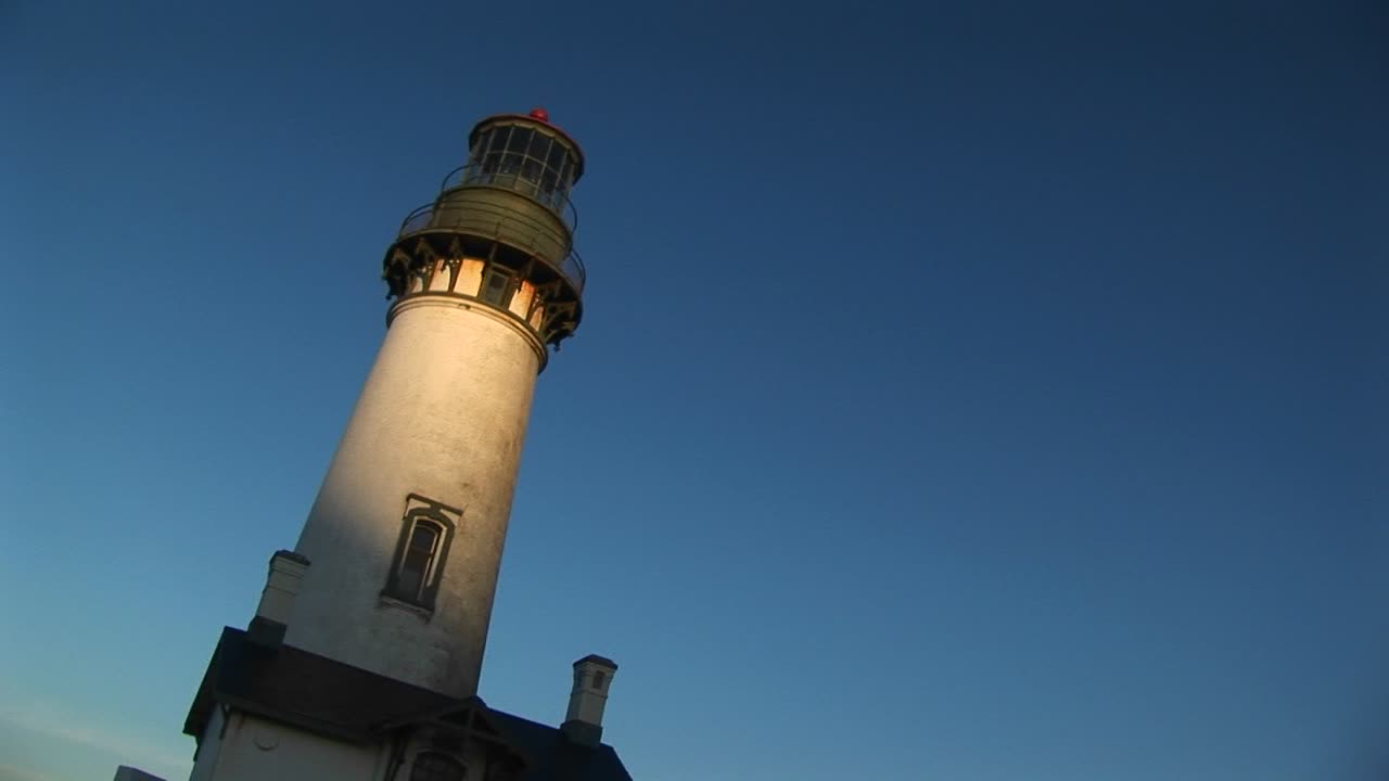 一座灯塔的手持欢乐景观,其白塔上有阳光