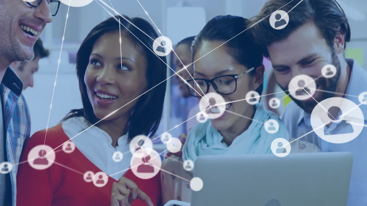 Six colleagues collaborating around laptop in business office showing network icons linking avatars