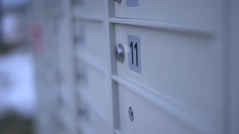 closeup of community mailbox during winter - canadian modern canada post mail boxes set in the neighbourhood community with numbers