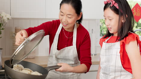 Mother,-girl-and-Asian-family-cooking-on-stove