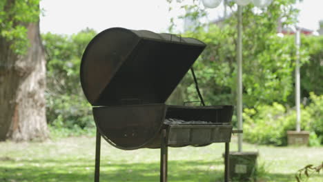 metal barbecue or bbq barrel for coal cooking in backyard or camping site