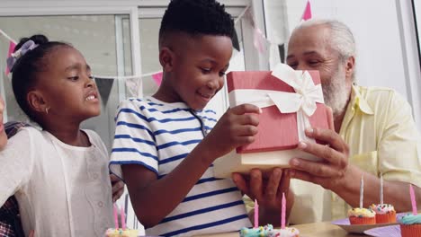 Mature-couple-enjoying-time-with-their-grandchildren