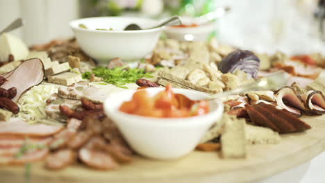 fresh hams and meat products on a rustic table during a party